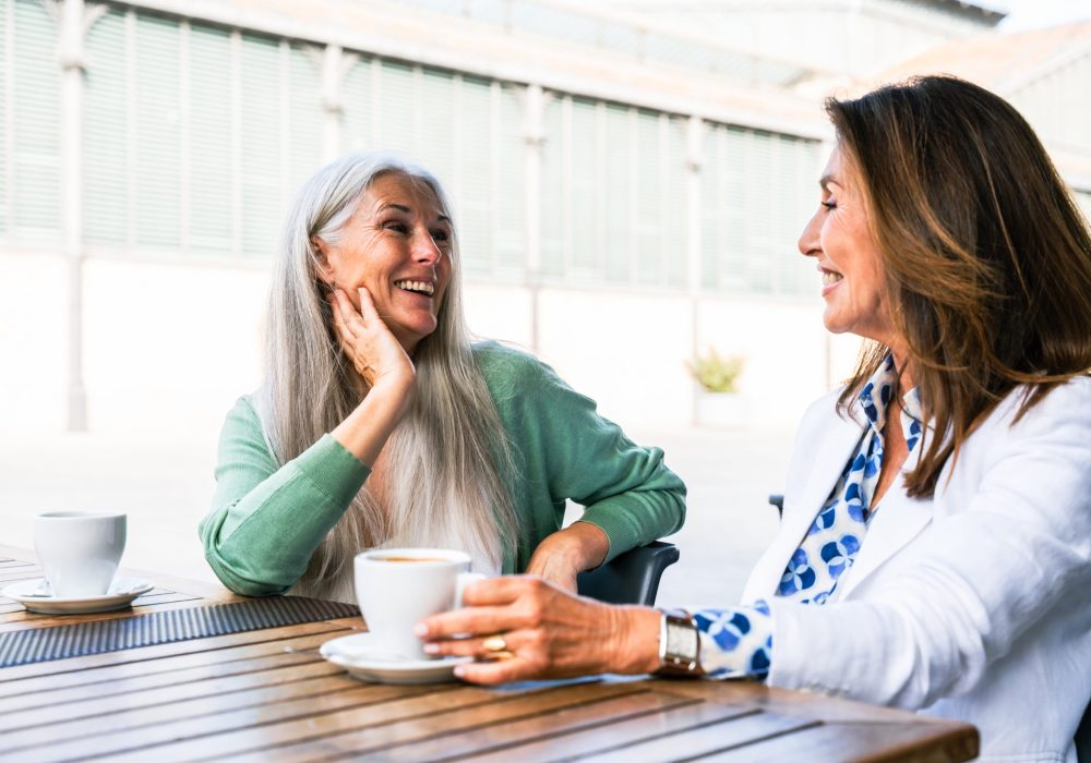 Beautiful senior women bonding outdoors in the city - Attractive cheerful mature female friends having fun, shopping and bonding, concepts about elderly lifestyle