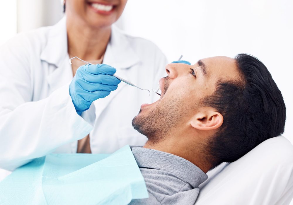 Man, dentist and check teeth with tools for dental cosmetics, healthcare assessment or medical consulting. Patient, tooth or open mouth in oral cleaning with mirror, excavator or orthodontics surgery.