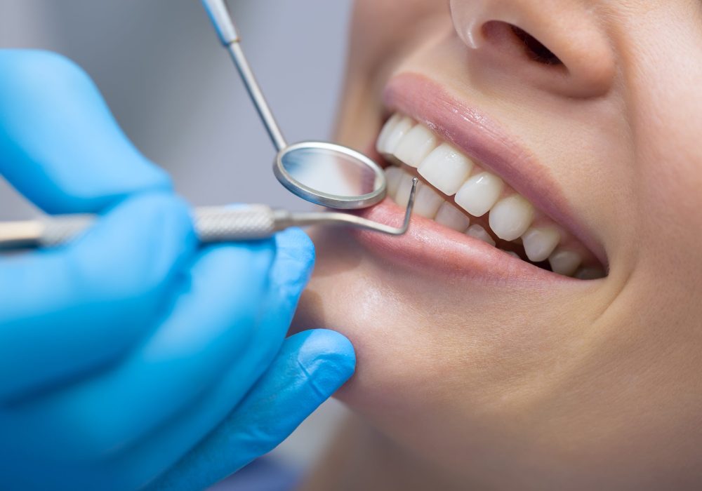 Girl with beautiful white teeth on reception at the doctor dentist.