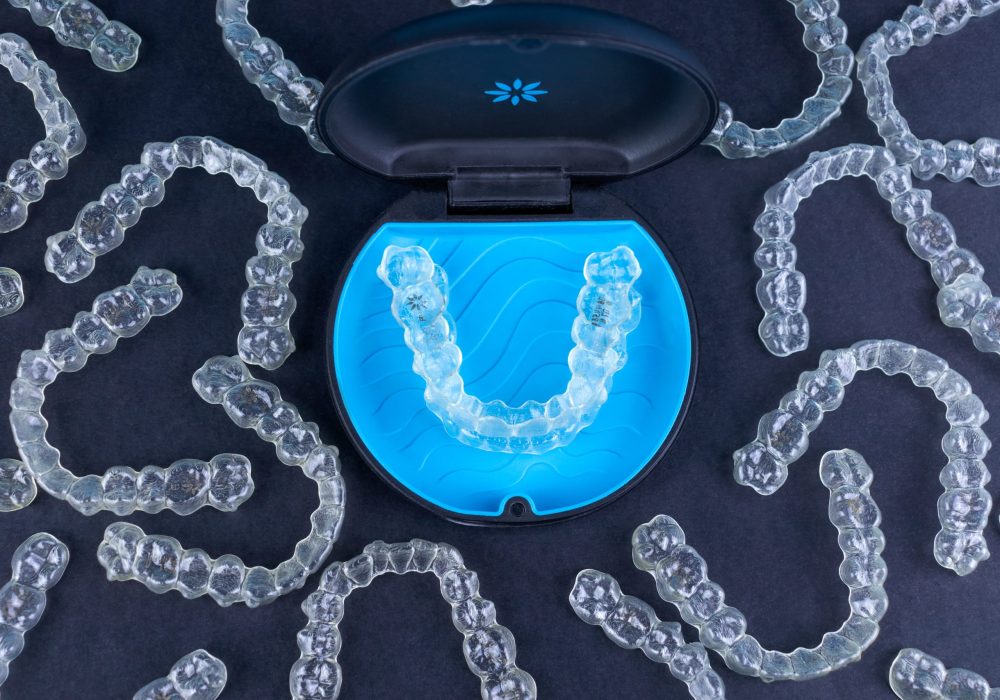Plastic case with invisible transparent orthodontic retainers invisalign. Aligner brackets or braces dental container