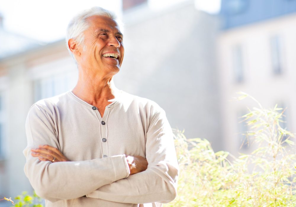 Portrait handsome man smiling with arms crossed and looking away